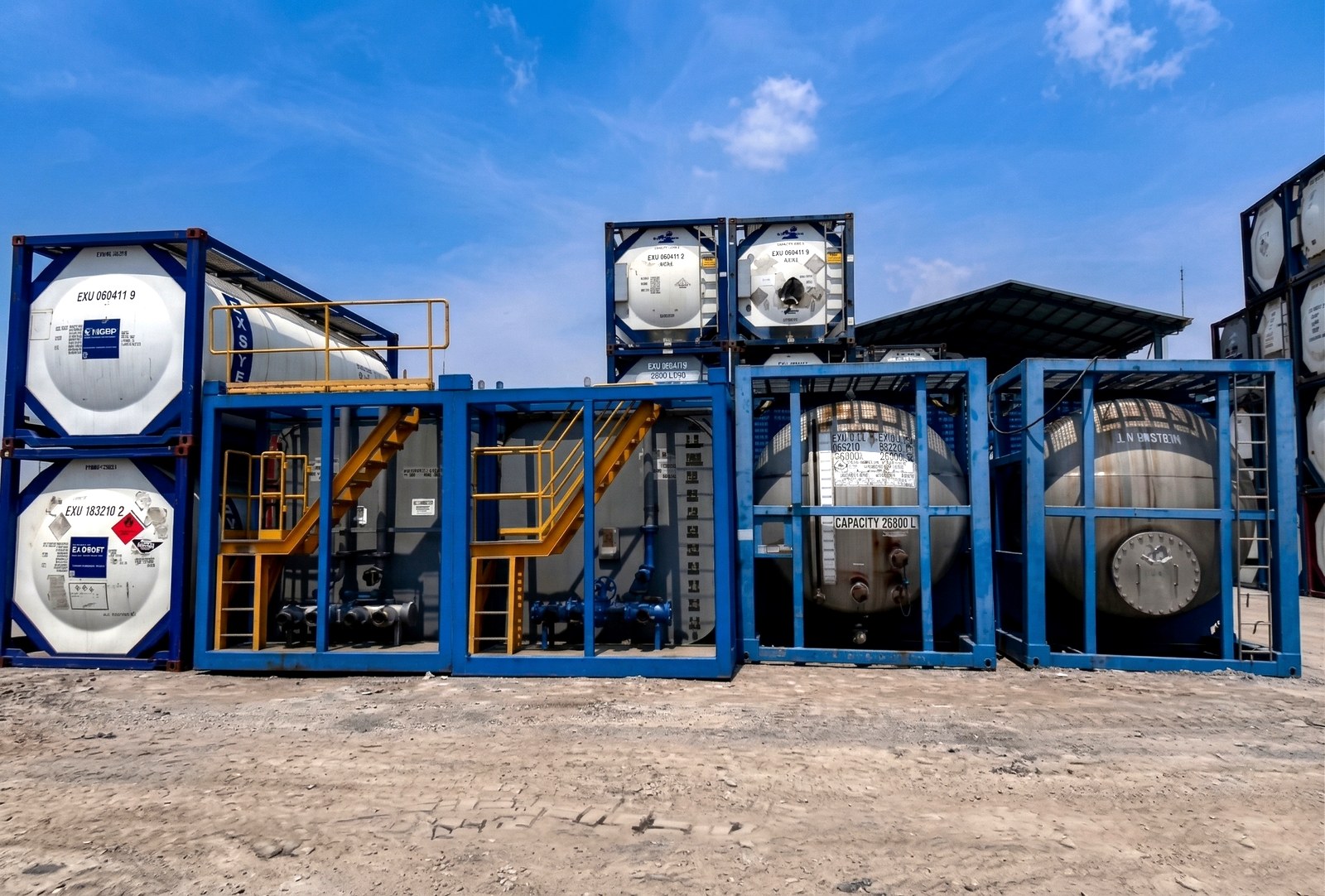 ISO-framed mixing and storage tanks staged at the Narogong yard