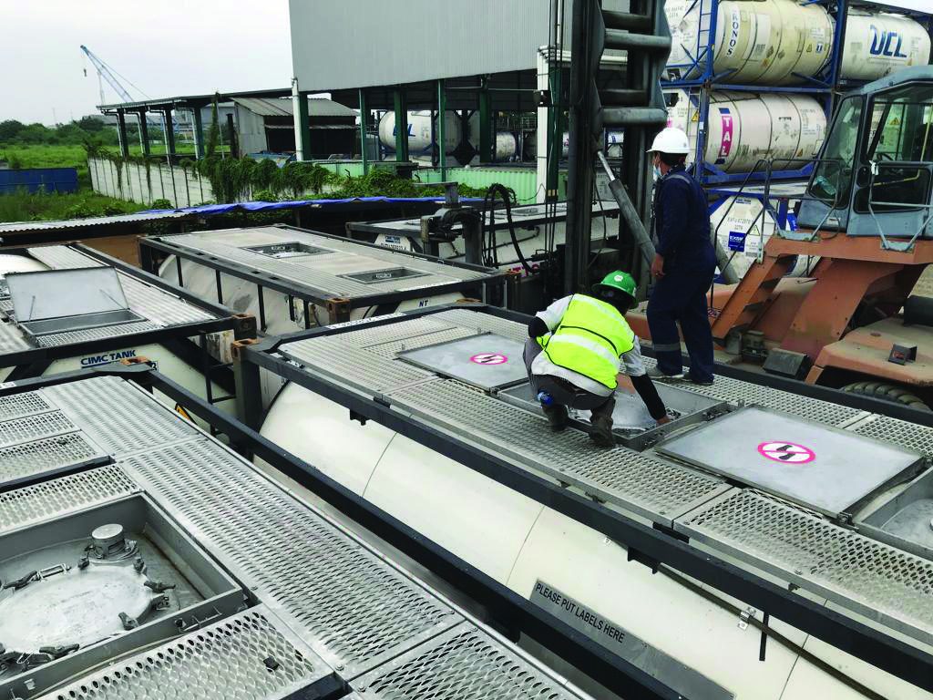 Crew working on top of tank farm