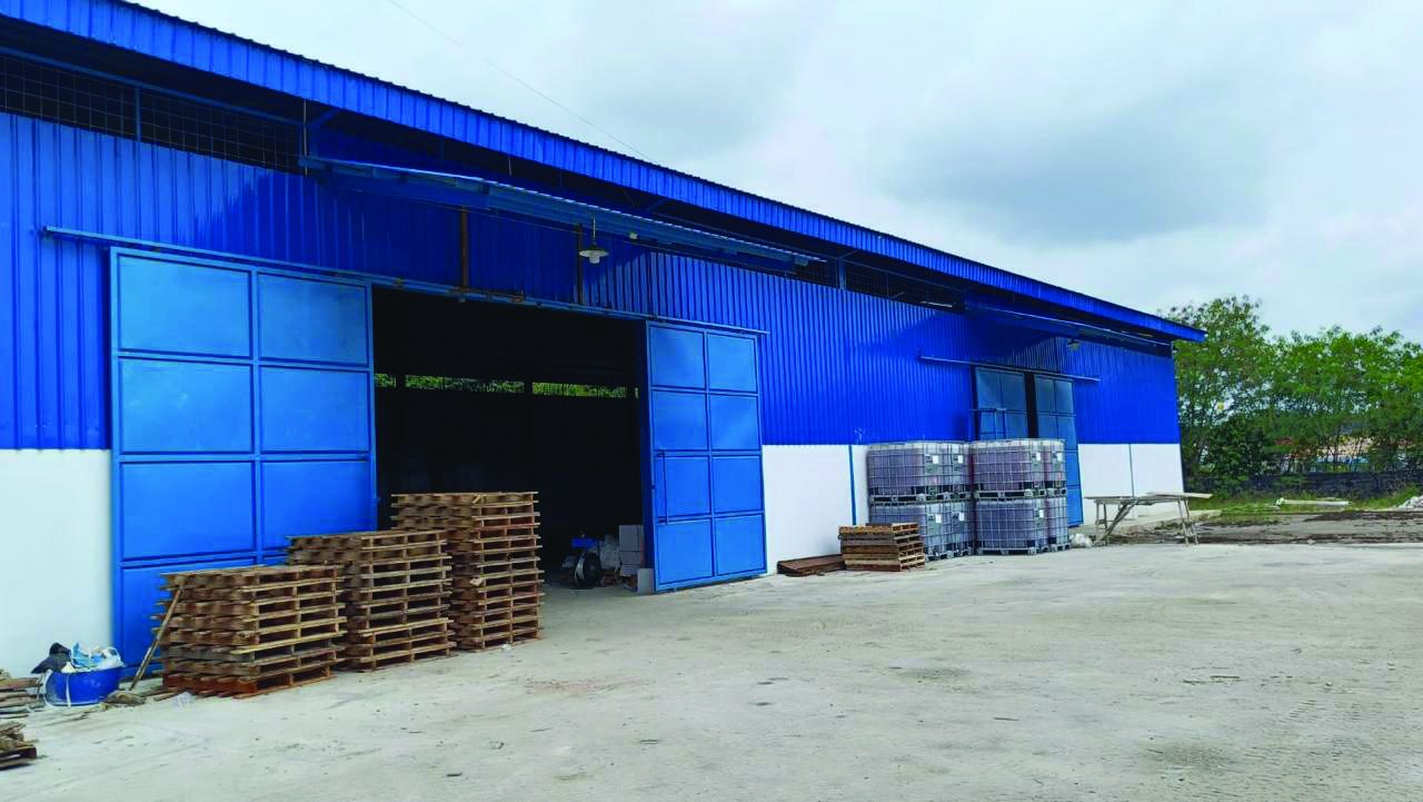 Blue warehouse building at Duri base